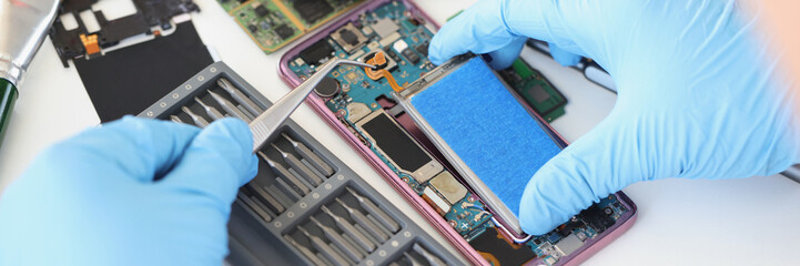 Sticker - Hands with tweezers repairing a battery from a smartphone