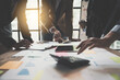 © PaeGAG - Team Business people are analyzing and brainstorming, using calculator, hands pointing financial data on a sheet, Team work process concept.