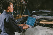 garage mechanic car engine engineer woman staff worker using laptop computer turning engine or check ECU combustion control
