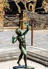 Wall Mural - statue of the dancing faun in Pompeii, Italy. Pompeii is an ancient Roman town destroyed by vesuvius eruption in 79 BC