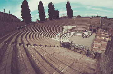 Wall Mural - Pompeii, Italy - May 30, 2015: view with fisheye of Tourists about the ancient Pompeii theater. Pompeii was victim to the 79 A.D. eruption of Mount Vesuvius.