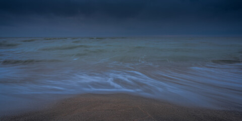 Wall Mural - An autumn seascape waves and dark clouds