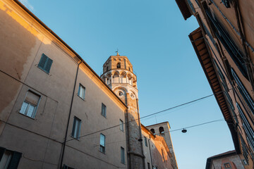 Wall Mural - Old vintage church building at sunset in a historic cozy European town in Italy