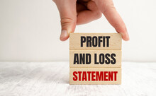 Business Photo Shows Profit And Loss Statement Words On Wooden Blocks And Hand
