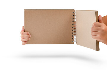 Wall Mural - Notepad isolated on white background. Brown notepad made from recycled paper on a white background in the hands of a child