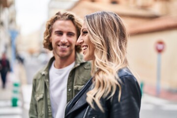 Man and woman couple smiling confident standing together at street