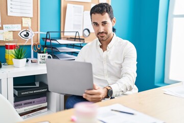 Sticker - Young hispanic man business worker using laptop working at office