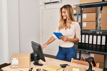 Poster - Young blonde woman ecommerce business worker using touchpad working at office