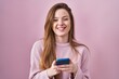 © Krakenimages.com - Young caucasian woman using smartphone typing message smiling and laughing hard out loud because funny crazy joke.