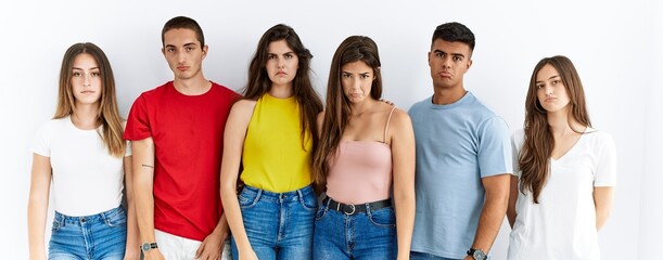 Canvas Print - Group of people wearing casual clothes standing over isolated background depressed and worry for distress, crying angry and afraid. sad expression.