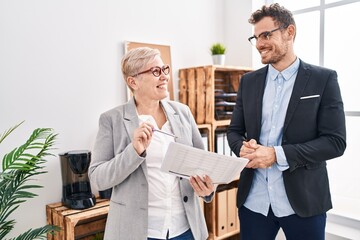 Canvas Print - Mother and son business workers reading document at office