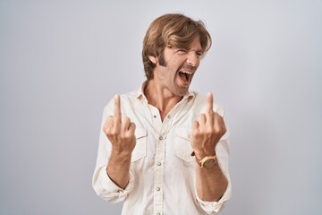 Poster - Middle age man standing over isolated background showing middle finger doing fuck you bad expression, provocation and rude attitude. screaming excited