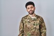 © Krakenimages.com - Arab man wearing camouflage army uniform looking sleepy and tired, exhausted for fatigue and hangover, lazy eyes in the morning.