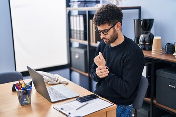 Canvas Print - Young arab man business worker suffering for wrist pain at office