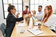 © Krakenimages.com - Group of business workers smiling and clapping to partners handshake at the office.