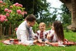 © New Africa - Happy family in Ukrainian national clothes on green grass outdoors