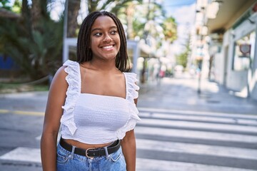 Wall Mural - Young african american girl smiling happy standing at the city.