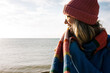 © Cavan Images - portrait of a woman smiling at the beach at sunset
