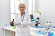 © Krakenimages.com - Senior grey-haired woman wearing scientist uniform standing with arms crossed gesture at laboratory