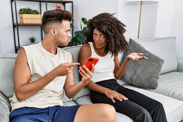 Canvas Print - Man and woman couple with problems using smartphone at home