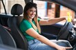 © Krakenimages.com - Young hispanic woman smiling confident driving car at street