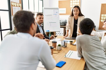 Wall Mural - Group of business workers listening boss conference during meeting at the office.