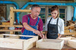 © ND STOCK - Tutor With Female Carpentry Student In Workshop Studying For Apprenticeship At College ,Teacher explaining a structure students while standing in a woodwork class