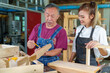 © ND STOCK - Teacher explaining a structure students while standing in a woodwork class