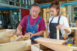 © ND STOCK - Teacher explaining a structure students while standing in a woodwork class