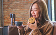 © Farknot Architect - Portrait image of a young woman holding coffee cup and a piece of chocolate chip cookie