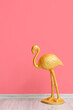 © Pixel-Shot - Golden flamingo near pink wall in room