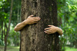 © witsarut - Human hand give hug to tree in forest.Concept of global problem of carbon dioxide and global warming.environment eco concept.