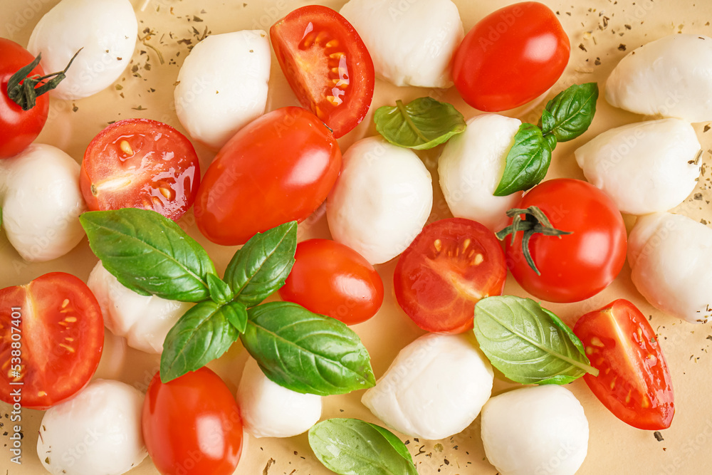 Composition with tasty mozzarella cheese, tomatoes and basil on color background, closeup