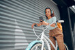 © Kay Abrahams/peopleimages.com - City travel, phone or bike for woman with radio headphones, podcast or music in Brazil road. Smile, happy or fashion student and mobile audio, eco friendly gps or future environment energy transport