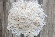 Flattened rice flakes on wooden texture, use to make healthy indian recipe poha