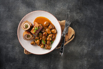 Wall Mural - Pork roulade with pickles and bacon, served with fried mushrooms and green onions