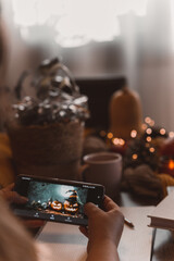 Wall Mural - autumn photo on table with candles watching smartphone