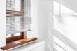 White Venetian blinds with sunlight and shadow. Window blinds. 