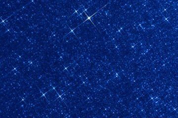 sparkling christmas texture. abstract blue background with sparkles in the shape of stars. festive b