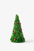 Small Christmas Tree Made Of Green Confetti And Red Baubles Against White Background