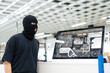 © Westend61 - Robber standing by computer at warehouse