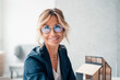 © Westend61 - Smiling real estate agent wearing eyeglasses at office