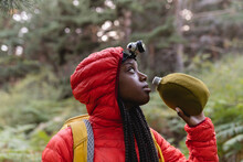 Thirsty Young Woman With Water Bottle In Forest