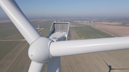 Canvas Print - Close up of wind turbine in field, Renewable energy made of windmill generator, Development of green wind energy due to energy crisis in Europe