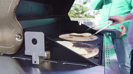 Wall Mural - Cooking flatbread on outdoor gas grill.