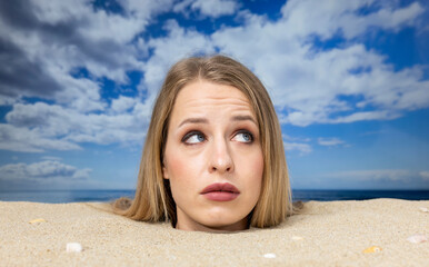 Wall Mural - Woman buried in sand on beach