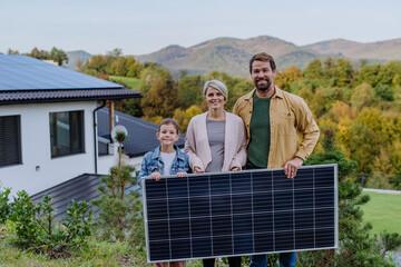 Wall Mural - Happy family near their house with solar panel. Alternative energy, saving resources and sustainable lifestyle concept.