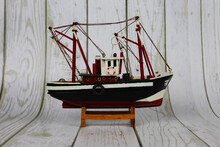 Wooden Model Of A Fishing Boat On A Stand. Decoration On The Shelf, Collecting Ships.