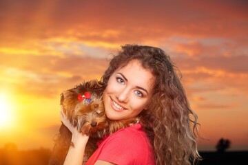 Poster - Smiling owner playing with young happy dog outdoor