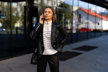 Attractive business woman talking on mobile phone with client.